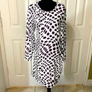 Brown and white long sleeve dress with lace up detail in back.